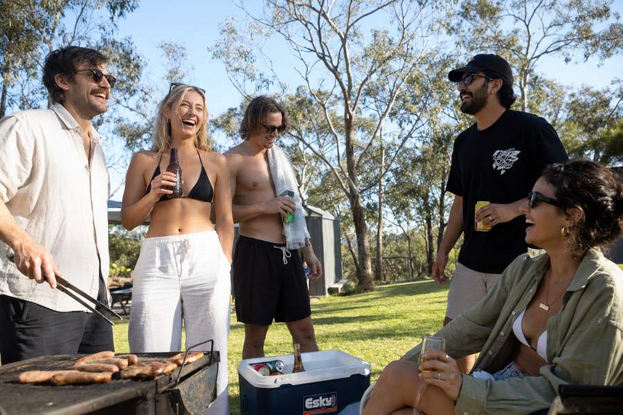 Friends laughing at an Australian backyard barbecue