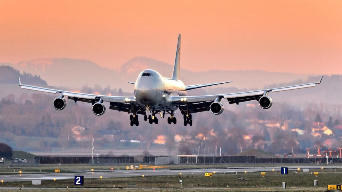 Boeing 747 on final approach at sunset